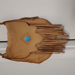 Hand made tan leather purse with turquoise stone and fringe.
